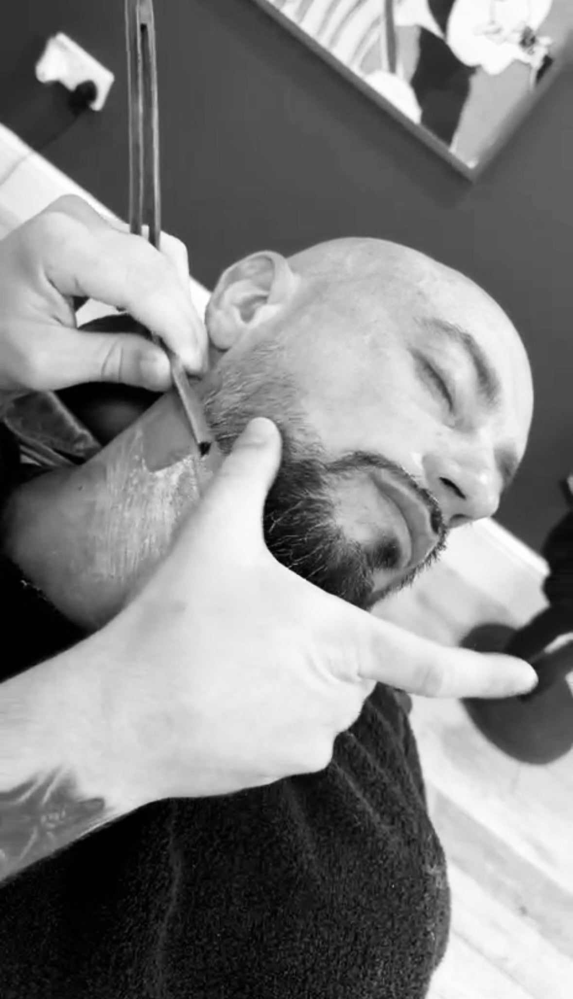 Bald man getting a shave in Hardwick barbershop