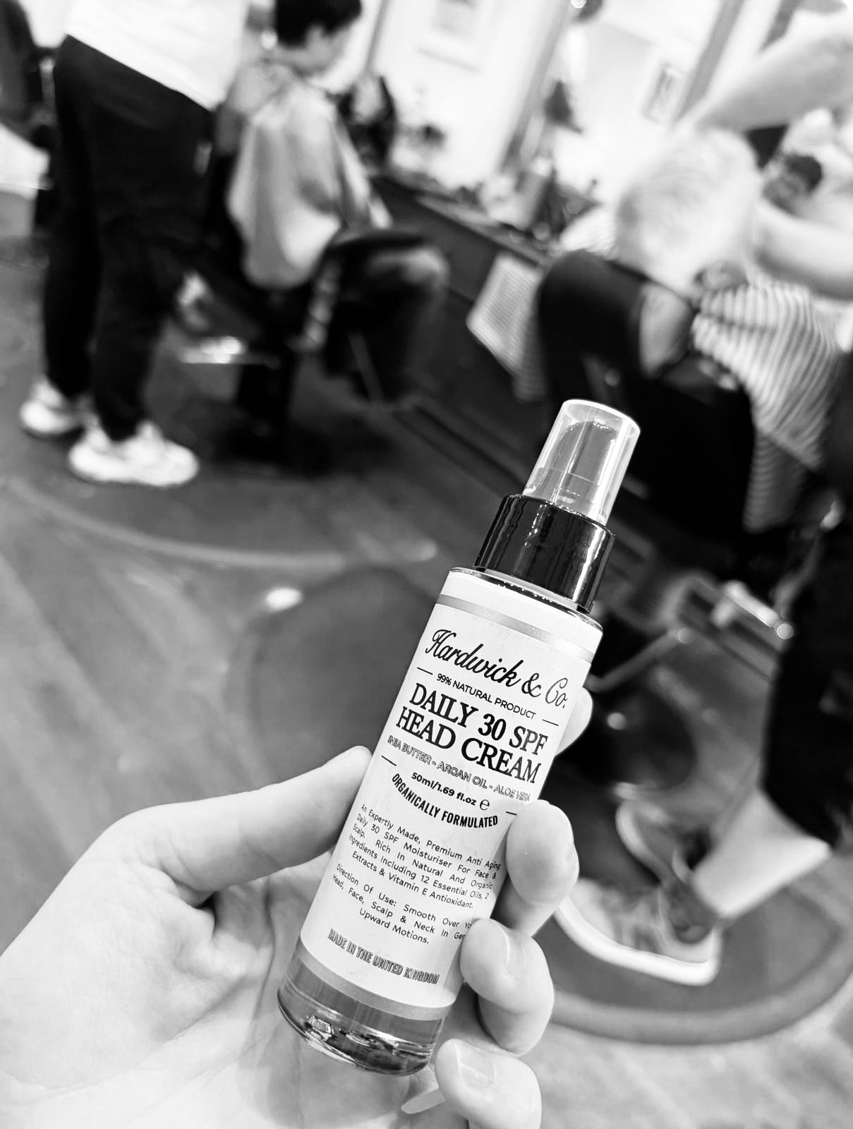 Hardwick & Co. Daily Spf 30 Head Cream Being Held By A Hand In The Barberbshop